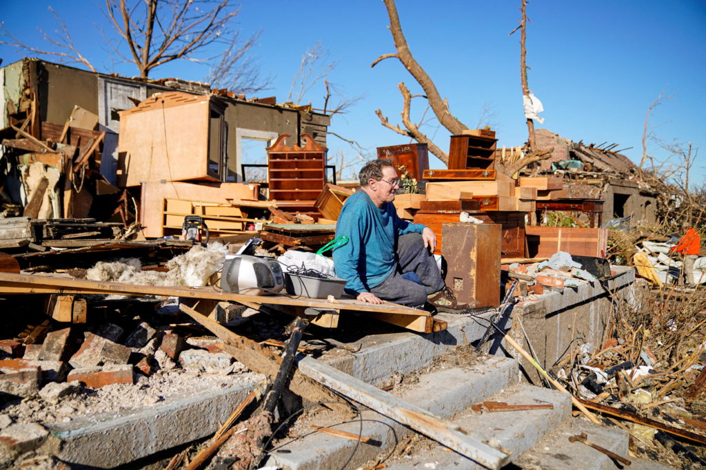 Rick Foley, 70, sits outside his home after a devastating outbreak of tornadoes ripped through several U.S. states in Mayfield, Kentucky, U.S. December 11, 2021. "I was in the middle of it, just trying to pull the pieces together now," said Rick who survived the storm crouched in a doorway inside his home. REUTERS/Cheney Orr     TPX IMAGES OF THE DAY